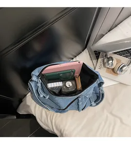 Macro view of blue denim tote bag interior showing large capacity for laptop and books