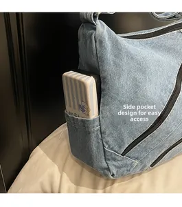 Detail view of denim tote bag side pocket for easy access to small essentials