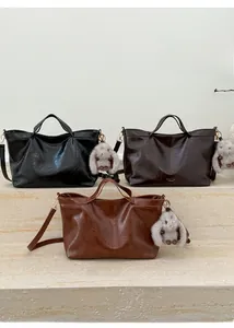 Detailed shot of vintage large tote bags in black, dark brown, and caramel faux leather