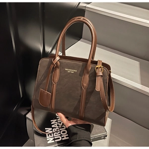 Detail der braunen Vintage-Einkaufstasche mit Lederstruktur und Bronze-Hardware