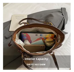 Detail showing high-capacity interior of dark brown tote bag with daily essentials