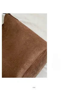 Detailed macro view of high-quality brown suede fabric on a large capacity tote bag