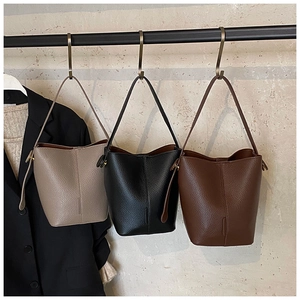 Detailed close-up showing three vintage bucket bags in taupe black and brown leather