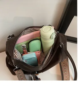 Interior view showing the large storage capacity of the brown suede crossbody pillow bag