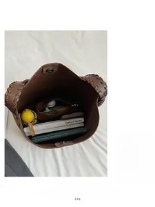 Top view showing large interior capacity of brown suede bucket bag with magnetic closure