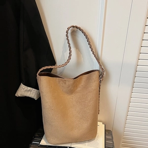 Minimalist brown suede bucket tote bag with long woven strap for casual autumn fashion