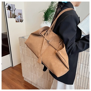 Detailed view of camel large capacity tote bag with matte texture and shoulder straps
