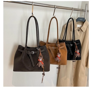 Detailed view of leather tote bags in three colors with cute bear charm and buckle details