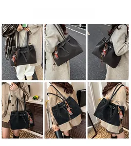 Detailed views of the large leather tote bag with lychee texture and bear charm