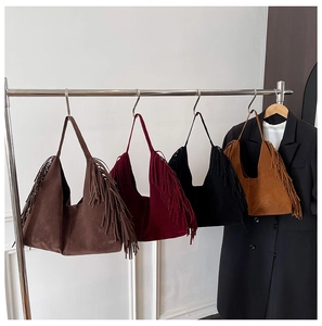 Detailed view of four retro frosted tote bags with long tassels in assorted colors
