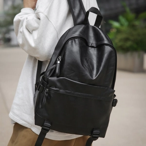 Detail view of large capacity black leather backpack with soft matte texture for commuting