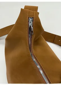 Detail of silver zipper and reinforced stitching on brown retro leather hobo bag