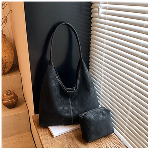 Detail of black matte tote bag with contrast stitching and matching zipper pouch