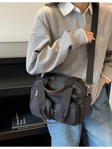 Minimalist black nylon multi-pocket crossbody tote bag with dual front zipper pockets