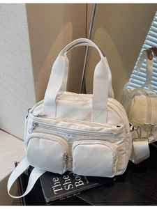 White nylon multi-pocket crossbody bag with detachable strap and metallic zippers