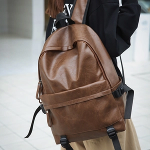 Detailed view of the vintage brown faux leather texture on this large capacity backpack