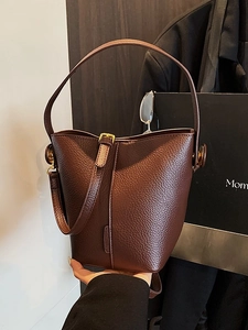 Deep brown bucket bag with litchi grain leather and gold buckle for stylish commuting