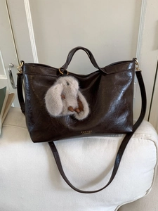 Vintage dark brown large leather tote bag with plush bunny charm and golden hardware