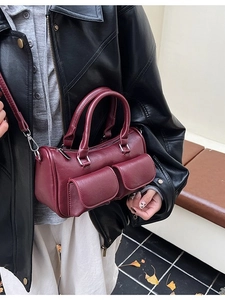 Deep red vintage Boston bag with side pockets and a detachable shoulder strap