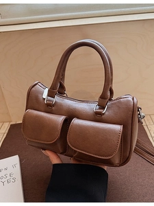 Vintage brown leather Boston bag with dual pockets and structured handles for women