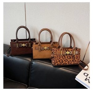 Three stylish leopard print and suede Boston bags with gold hardware detail