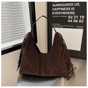 Detailed view of the dark brown suede hobo bag featuring long stylish fringe accents