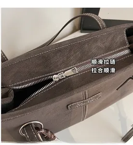 Detail of silver metal zipper and white contrast stitching on coffee tote bag