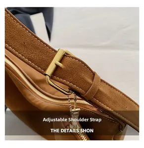 Detail of adjustable shoulder strap with gold metal buckle and contrast stitching on bag