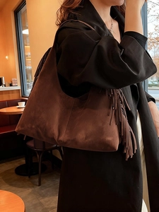Vintage brown suede shoulder bag with long tassels and crescent shape for women
