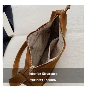 Internal layout of brown matte tote bag showing compartments and golden zipper details