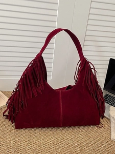 Retro dark red suede tote bag with long fringe details and a vintage hobo shoulder design