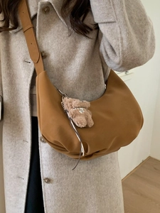 Retro brown half-moon crossbody bag with plush bear charm and adjustable strap