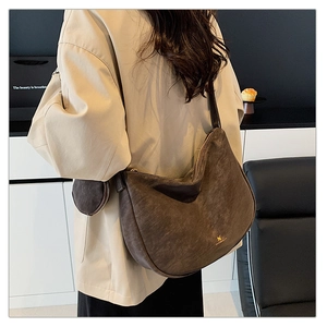 Detail of coffee hobo bag in faux suede with a round coin purse on an adjustable strap