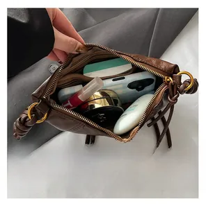 Top view showing the spacious interior and striped lining of this brown shoulder bag