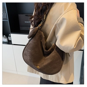Detail of vintage matte brown hobo bag with gold hardware and small zip pouch