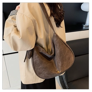 Deep brown matte hobo tote bag shown in use with elegant khaki trench coat