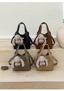 Detailed view of bucket bags in four colors with leather texture and rabbit charms