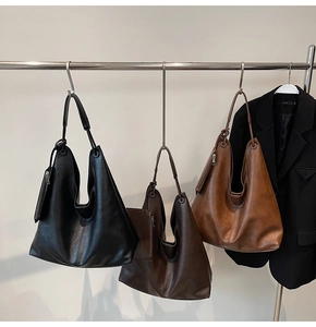 Detailed view of large capacity hobo tote bags in black, dark coffee, and tan faux leather