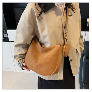 Detail of brown suede hobo bag with gold logo and detachable round coin purse
