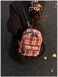 Autumn style mini backpack with red plaid pattern on an ginkgo leaf background