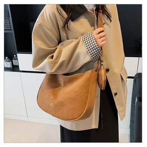 Detail of vintage matte brown tote bag with side coin purse and gold logo detail