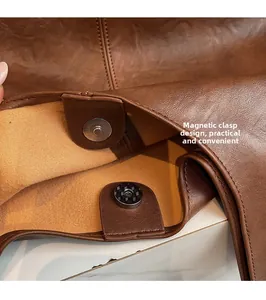 Close-up of secure magnetic closure on vintage brown faux leather hobo tote bag