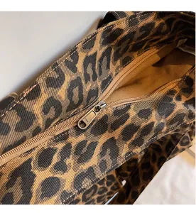 Close-up of high-quality YKK zipper hardware on stylish leopard print canvas tote bag