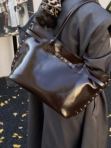 Chocolate patent leather tote bag with silver studs and long shoulder straps