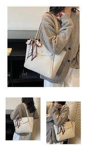 Gros plan d'un sac cabas beige avec texture grainée et détail d'un foulard en soie décoratif