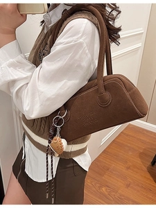 Brown vintage suede tote bag with top handles and baseball charm accessory