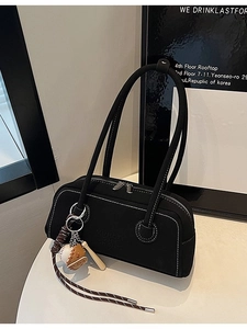 Retro black faux leather shoulder bag with white contrast stitching and baseball charm