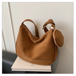 Detail of dark brown matte suede hobo bag with adjustable strap and coin purse accessory