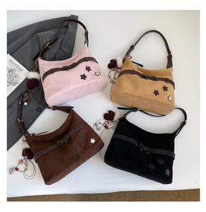 Flat lay of colorful suede hobo bags with star patches and cute bow accents