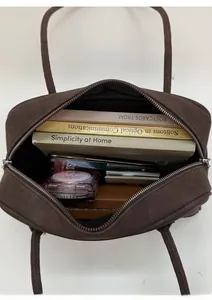 Detail view showing large interior capacity of brown matte leather shoulder bag with items